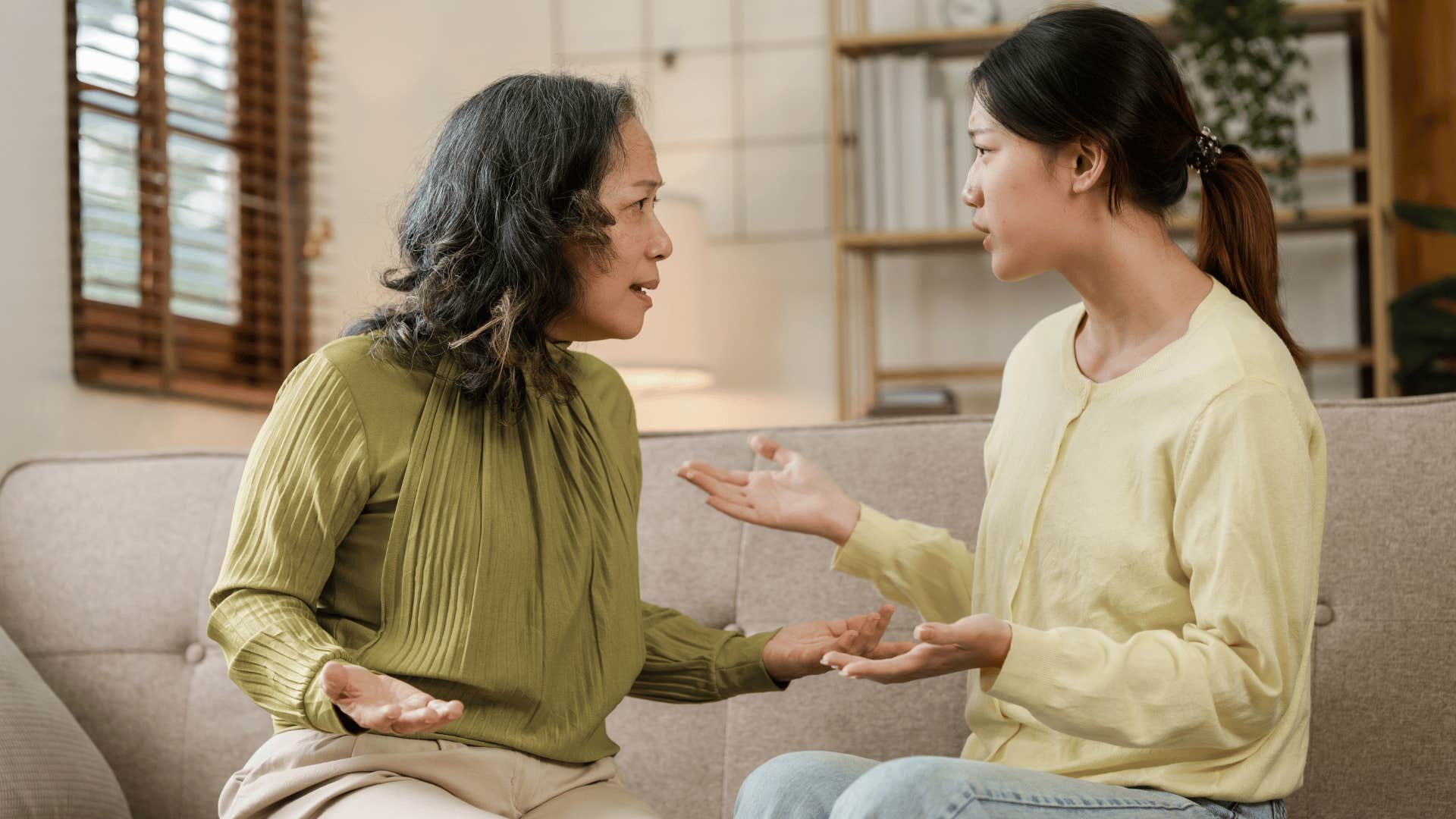 two women arguing on the couch