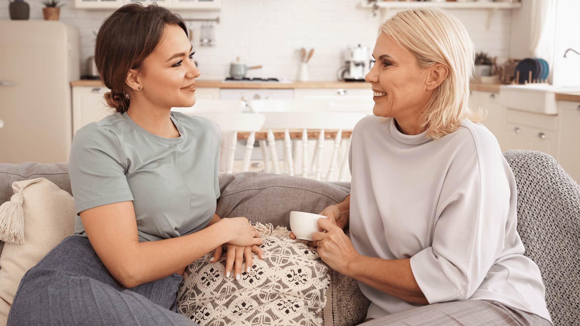 two women chatting on the couch