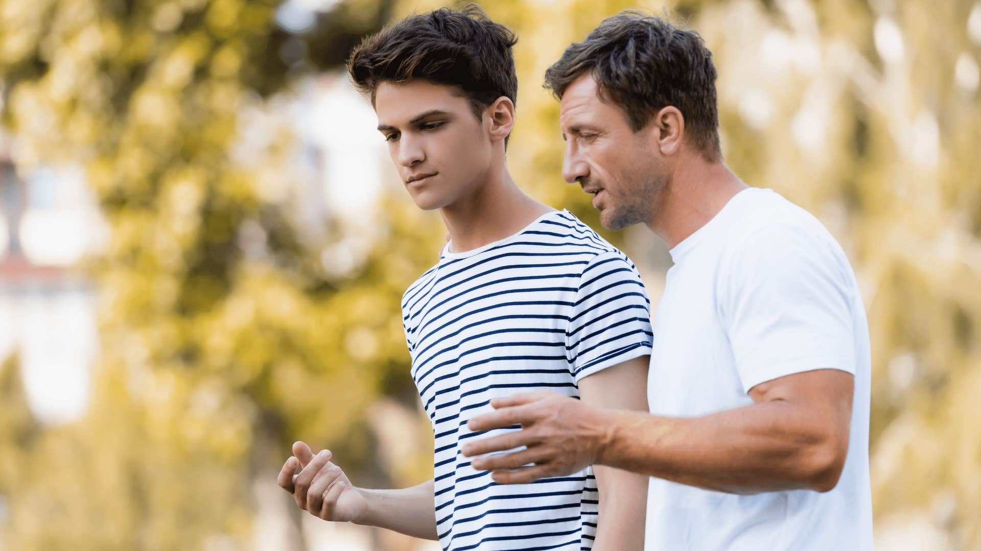 two men talking while walking 