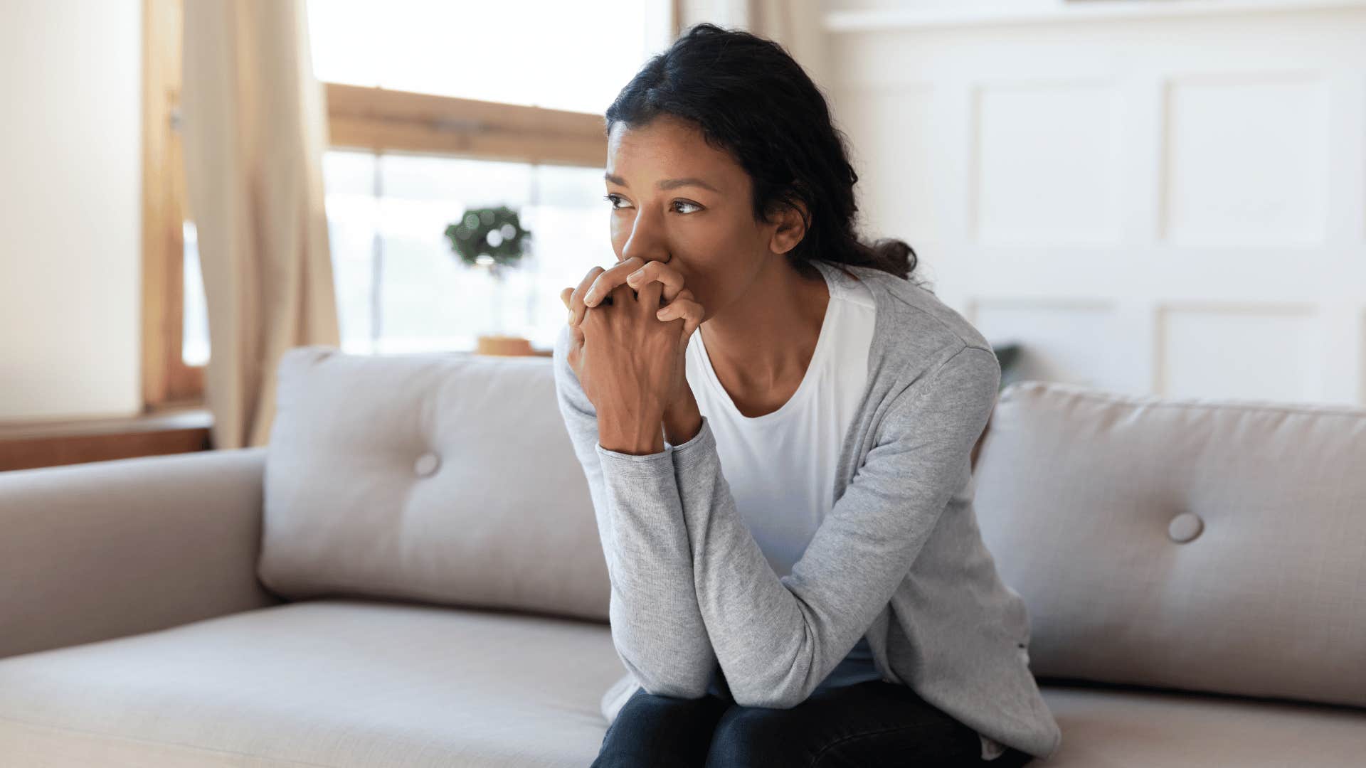 anxious woman on couch