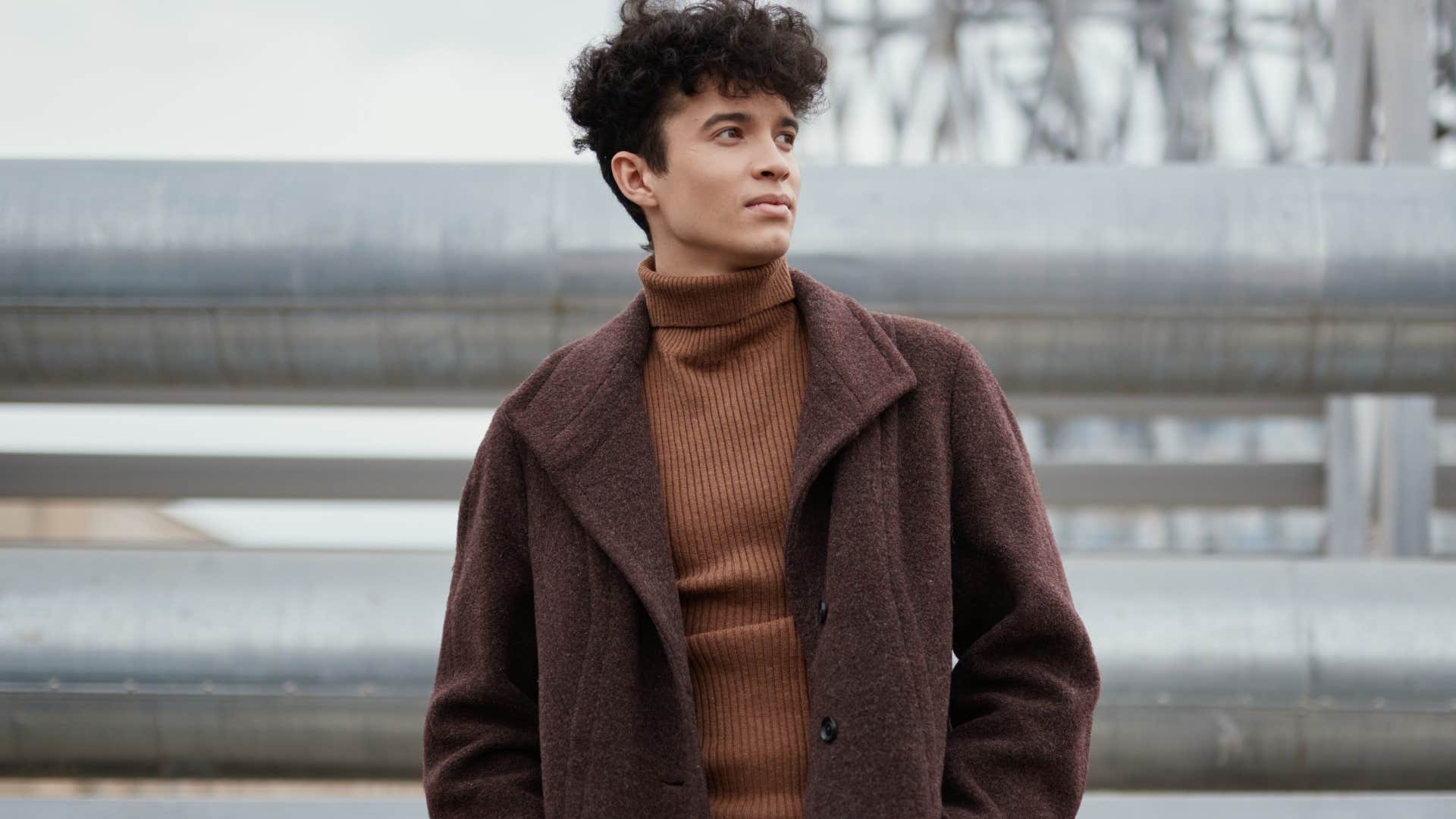 Fashionable young man standing outside.