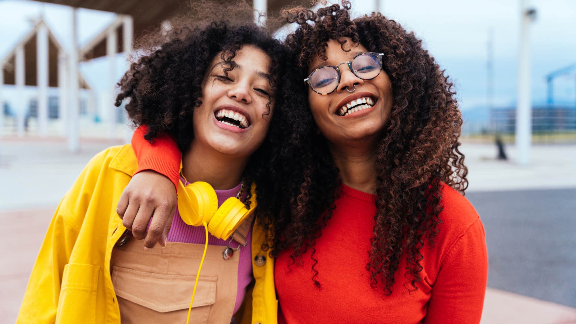 Two women smiling and laughing together.