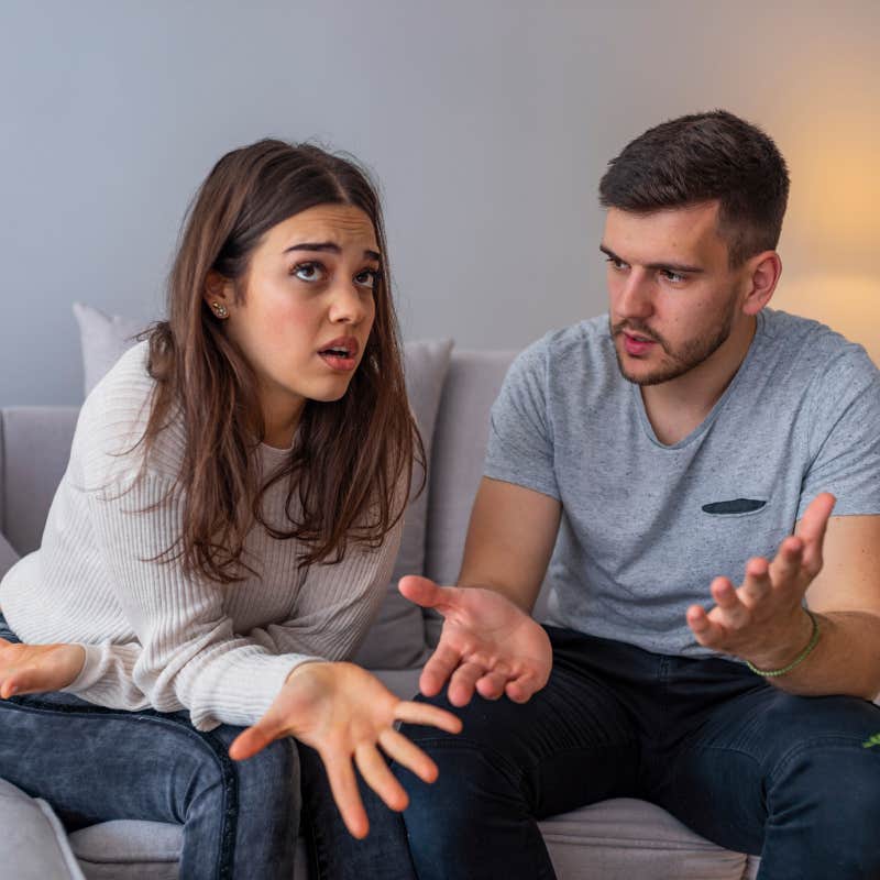 couple having conversation on couch at home