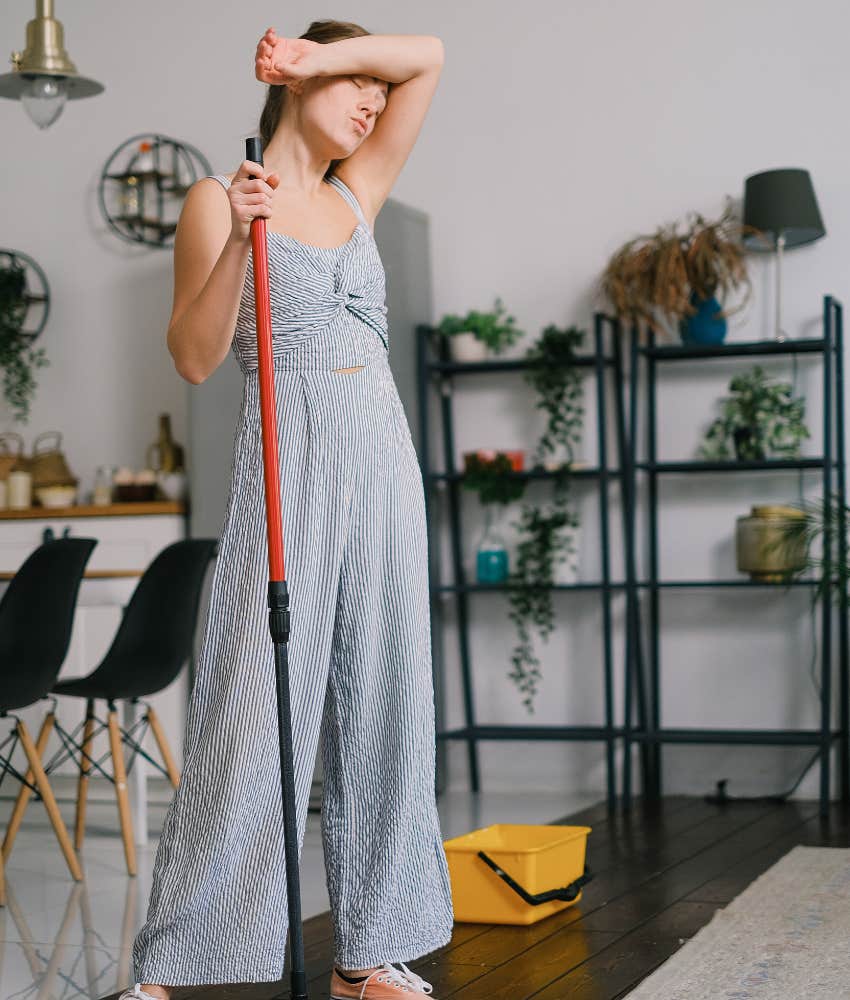 woman tired after mopping floors