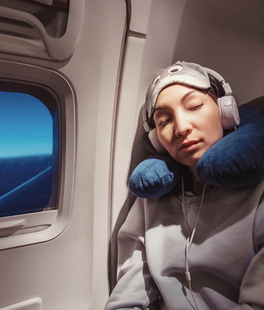 woman sleeping in window seat on plane