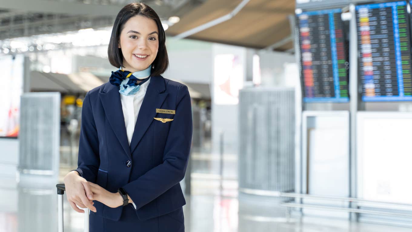 Portrait of Caucasian flight attendant standing in airport terminal