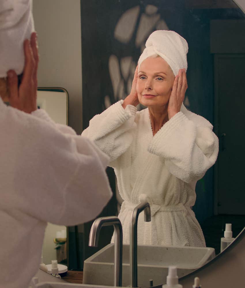 Woman looking in the mirror after a morning shower