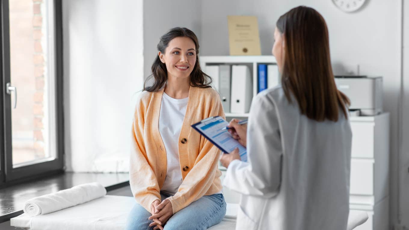 woman sitting and talking to doctor in office