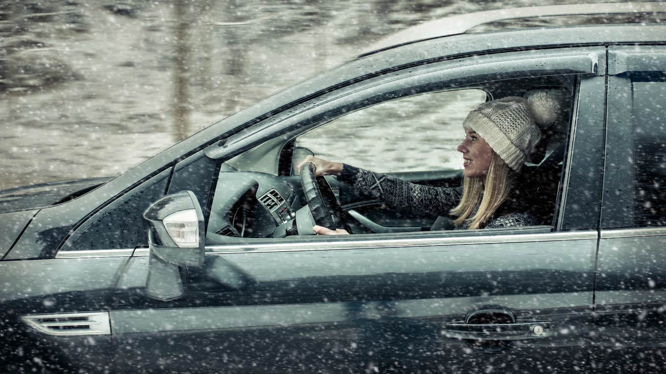 Woman driving through a blizzard to get to work