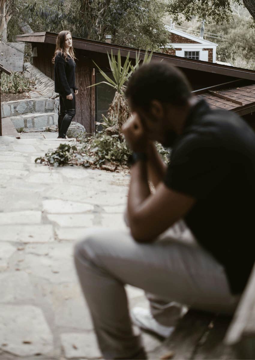 woman looking back at an upset man