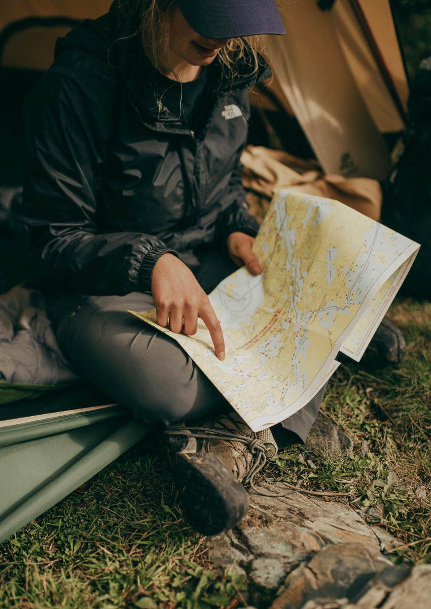 woman pointing at a paper map