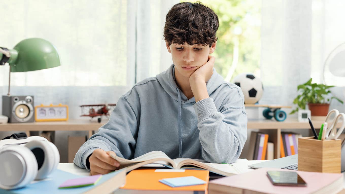 Teen boy reading a book