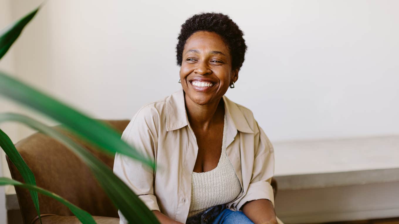 smiling, happy woman sitting in chair