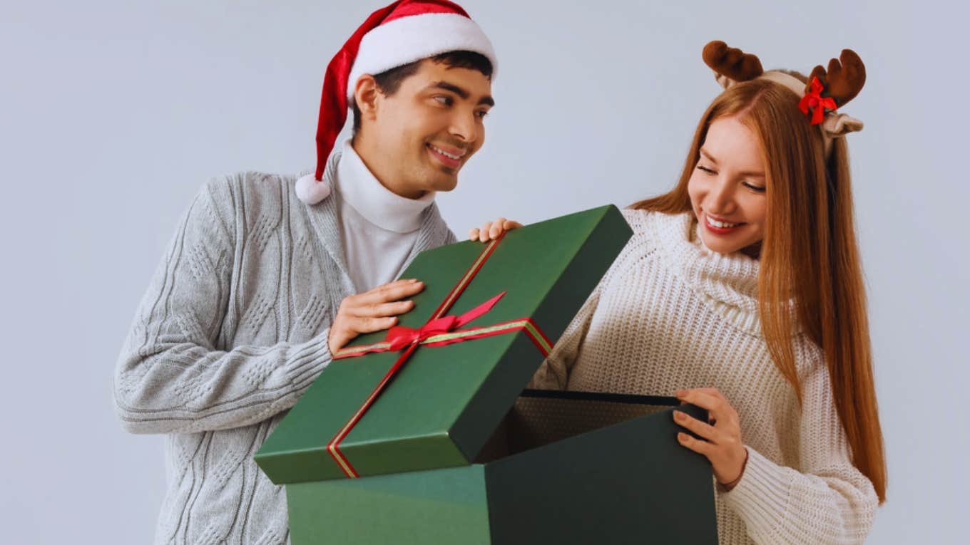 woman opening husband's christmas gift 