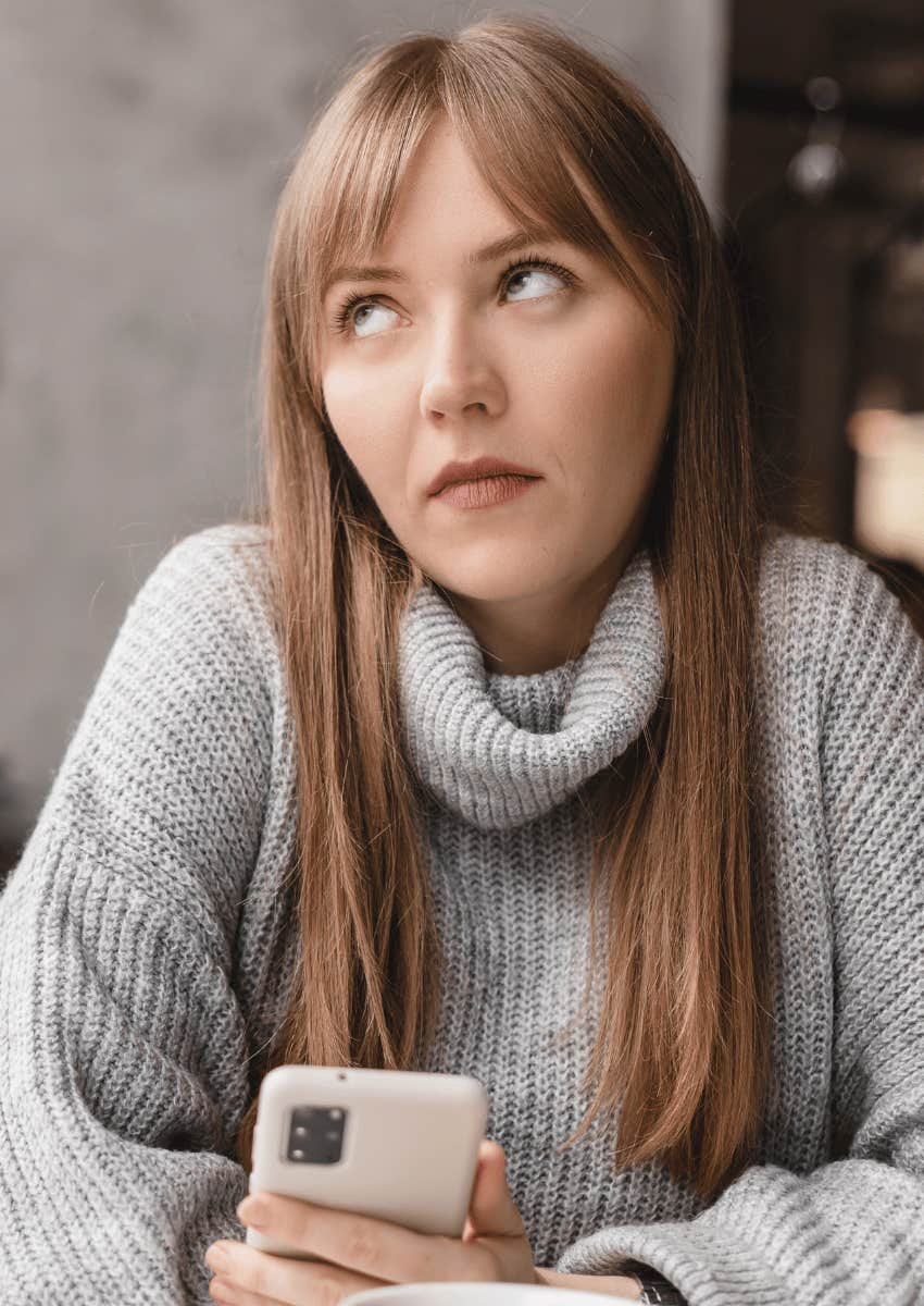 woman in a turtleneck sweater with an eyeroll