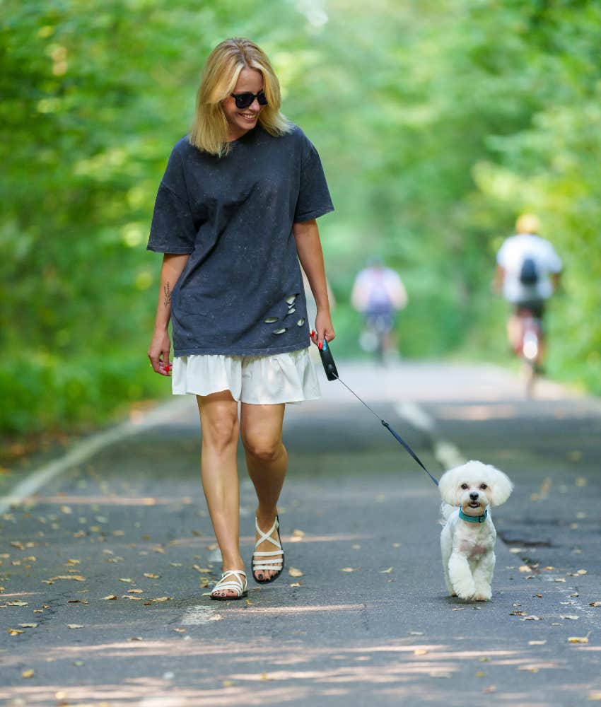 Woman outside walking her dog