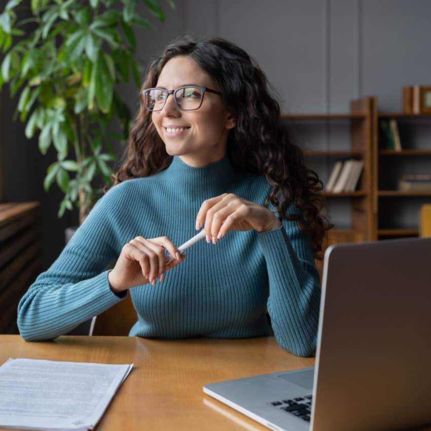 woman smiling while looking out window 