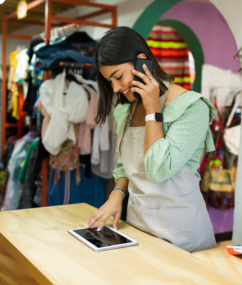 worker on the phone while covering retail shop