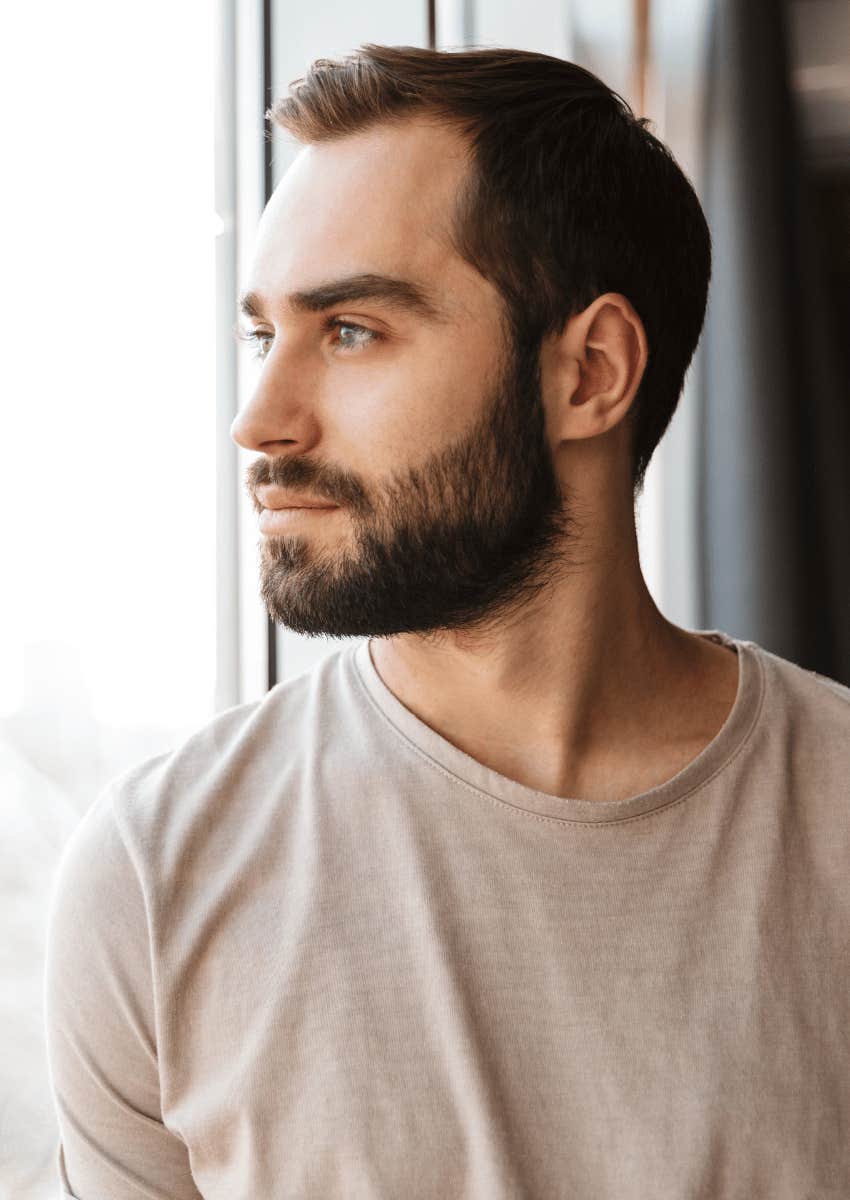 young man looking out of window