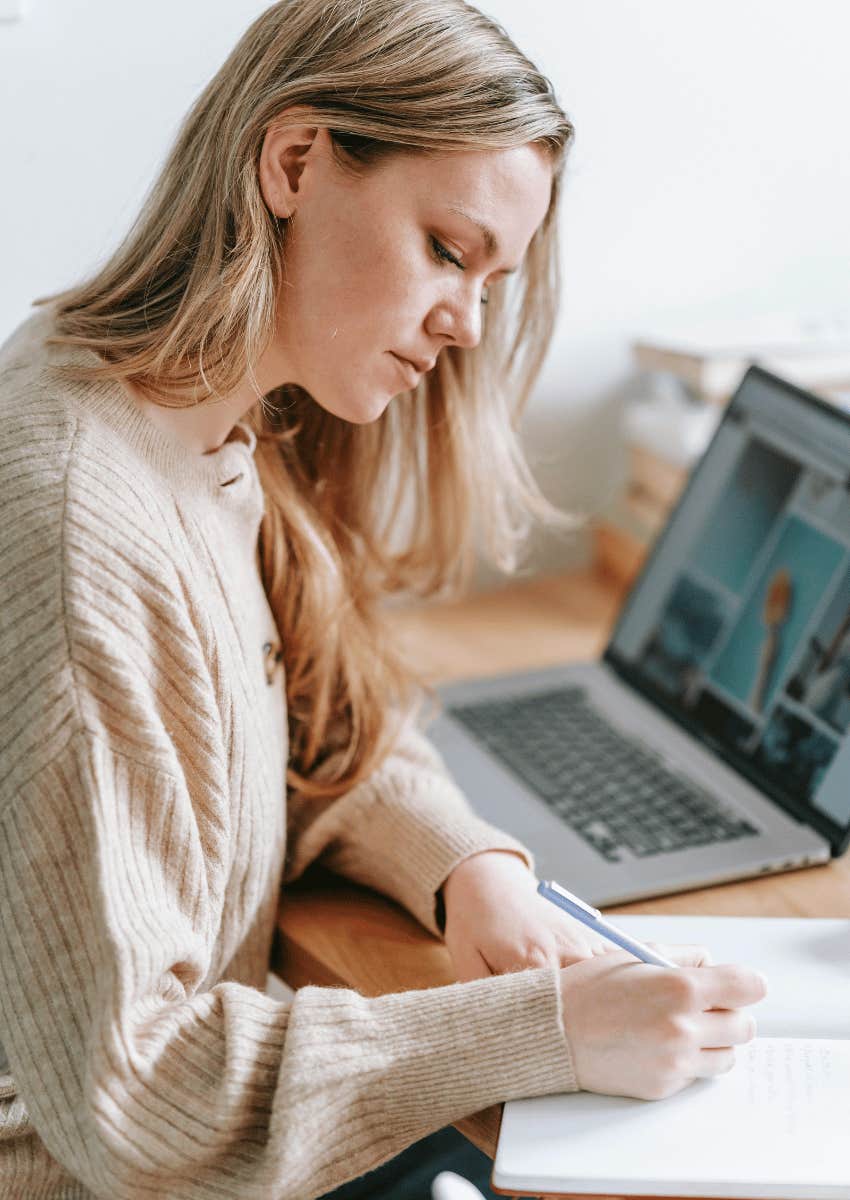 young woman writing in a notebook