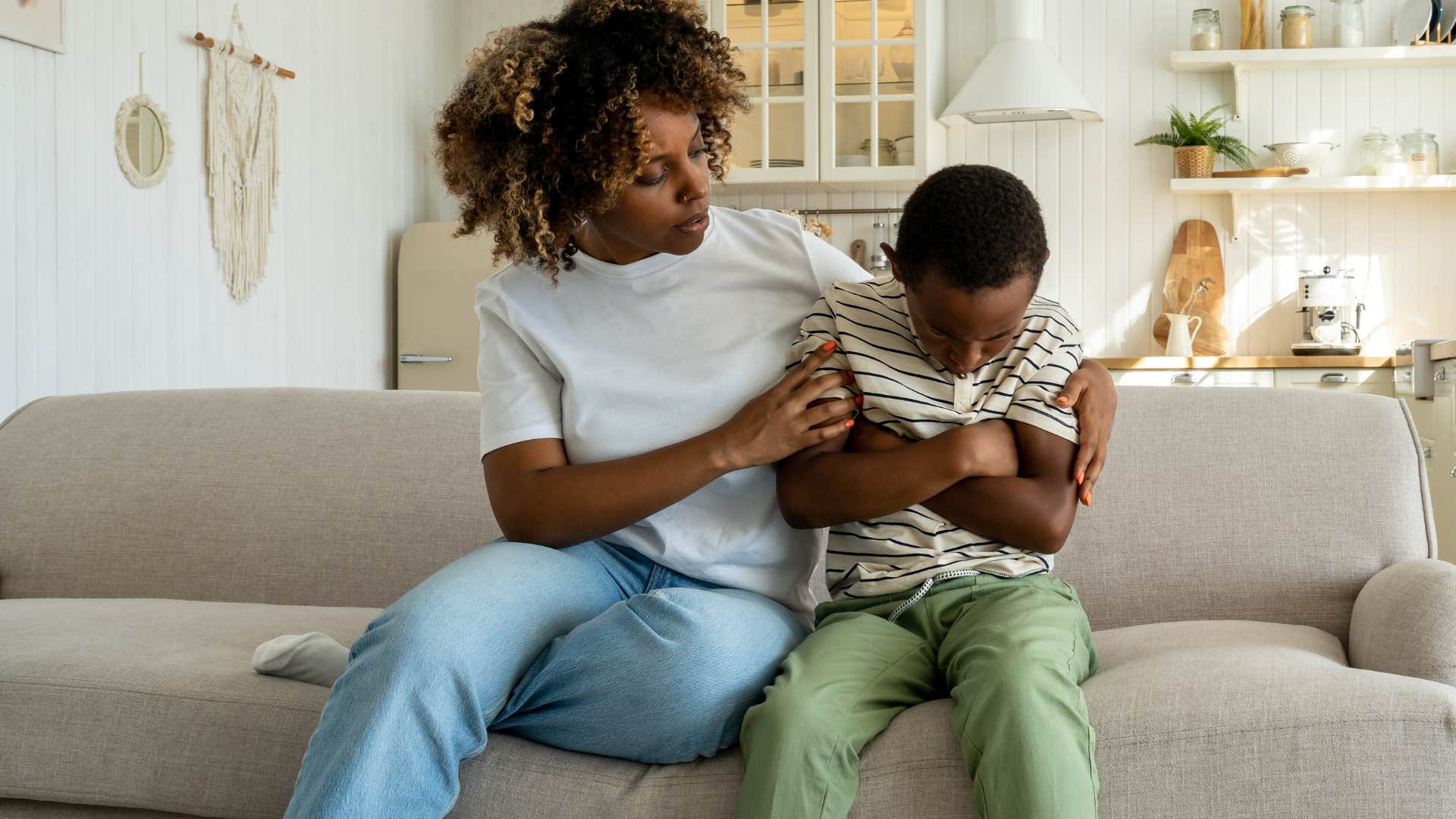 Woman comforting her upset son.