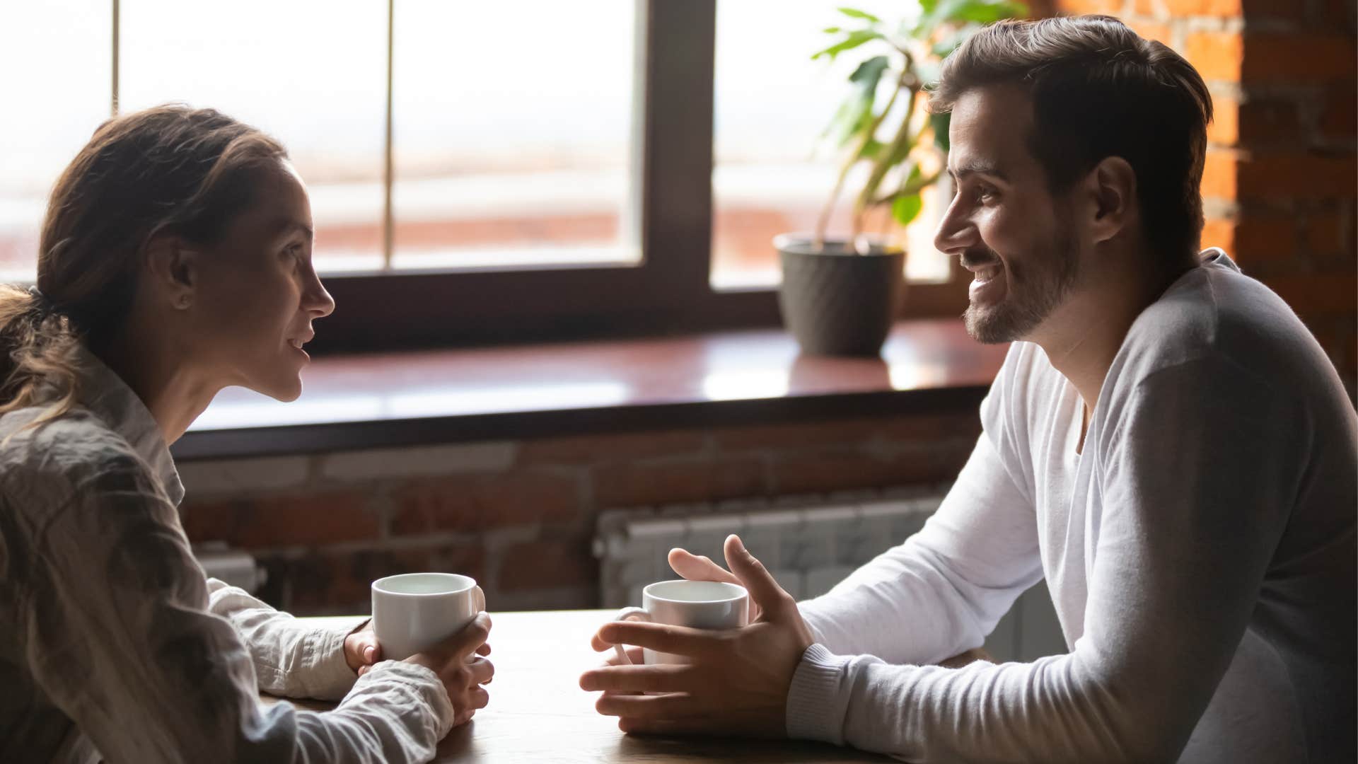 woman and man having a conversation over coffee