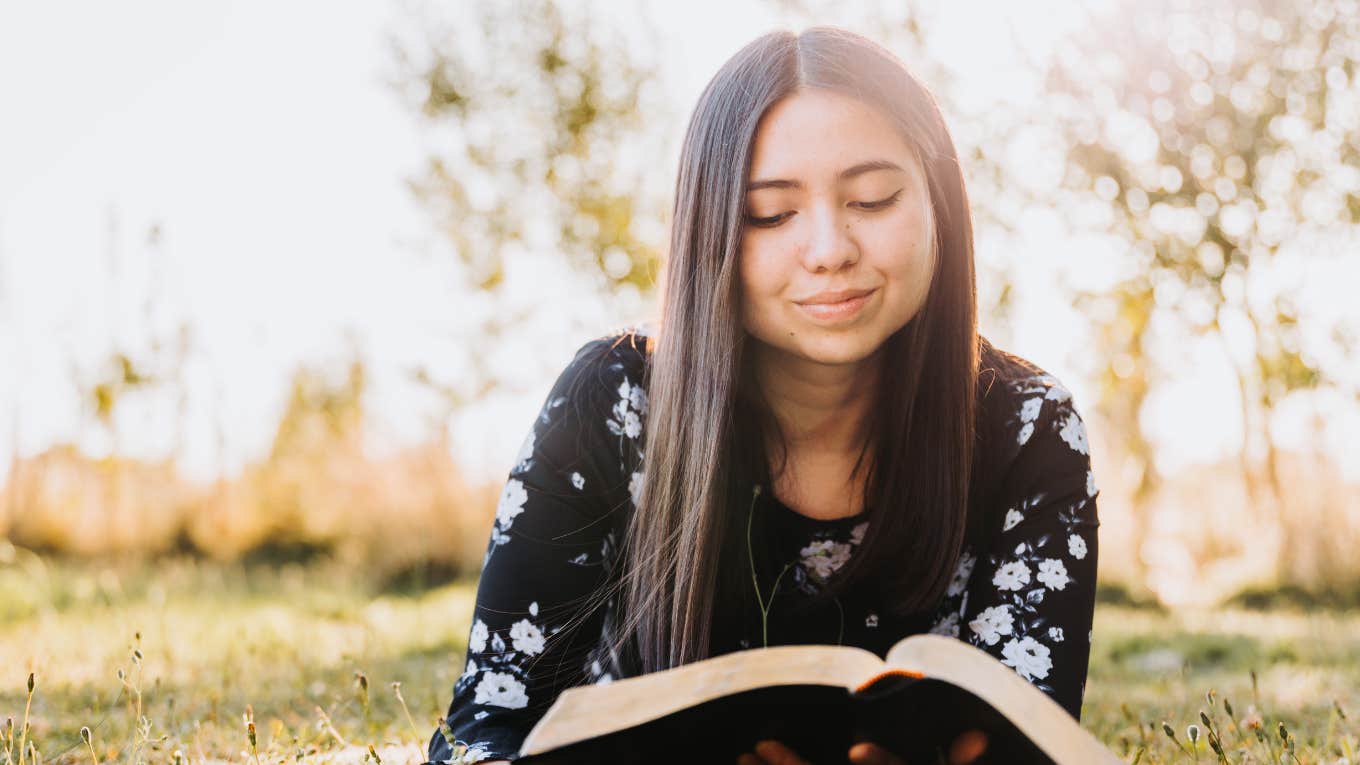 Young Christian woman reading bible to avoid lies in God's name