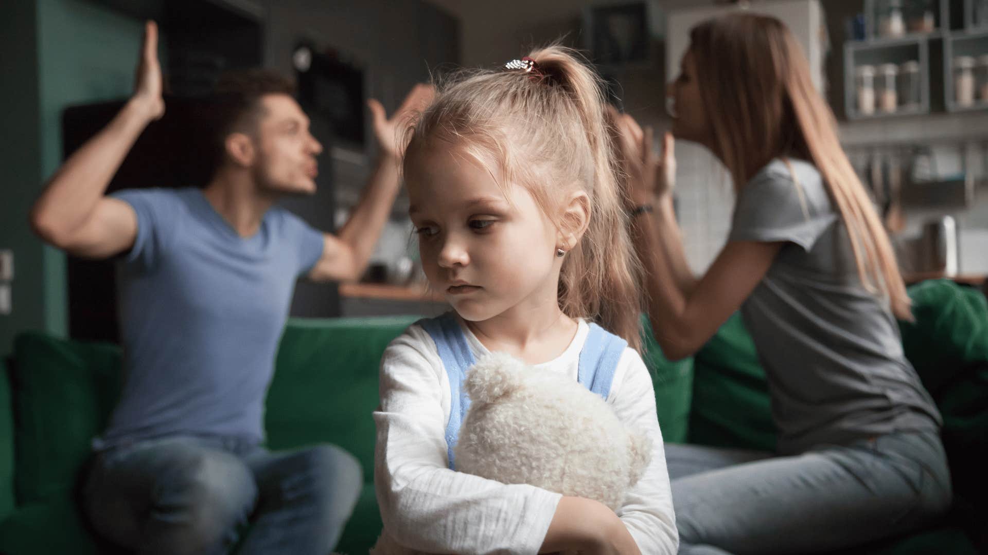 scared little girl listening to parents fight