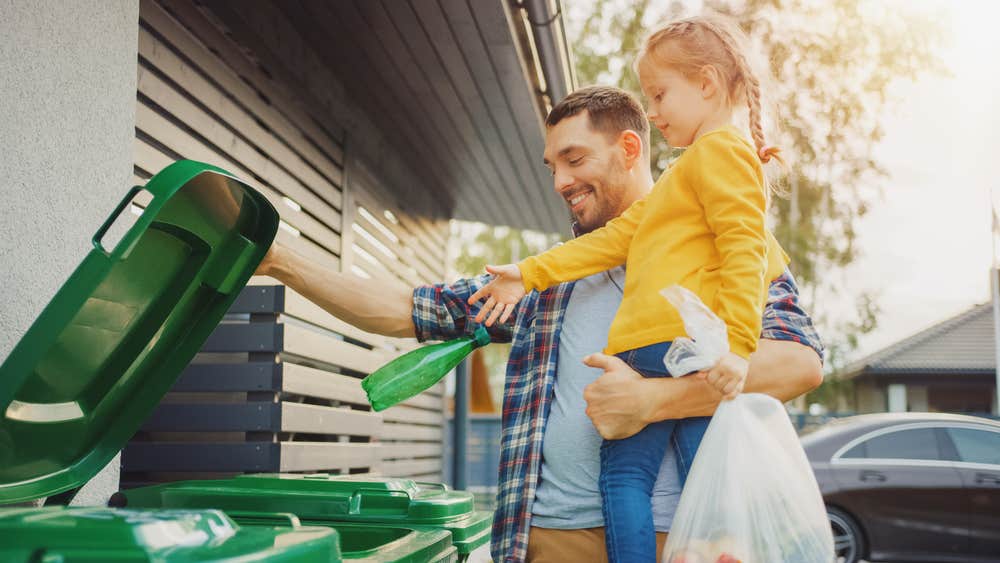 man and daughter taking out trash