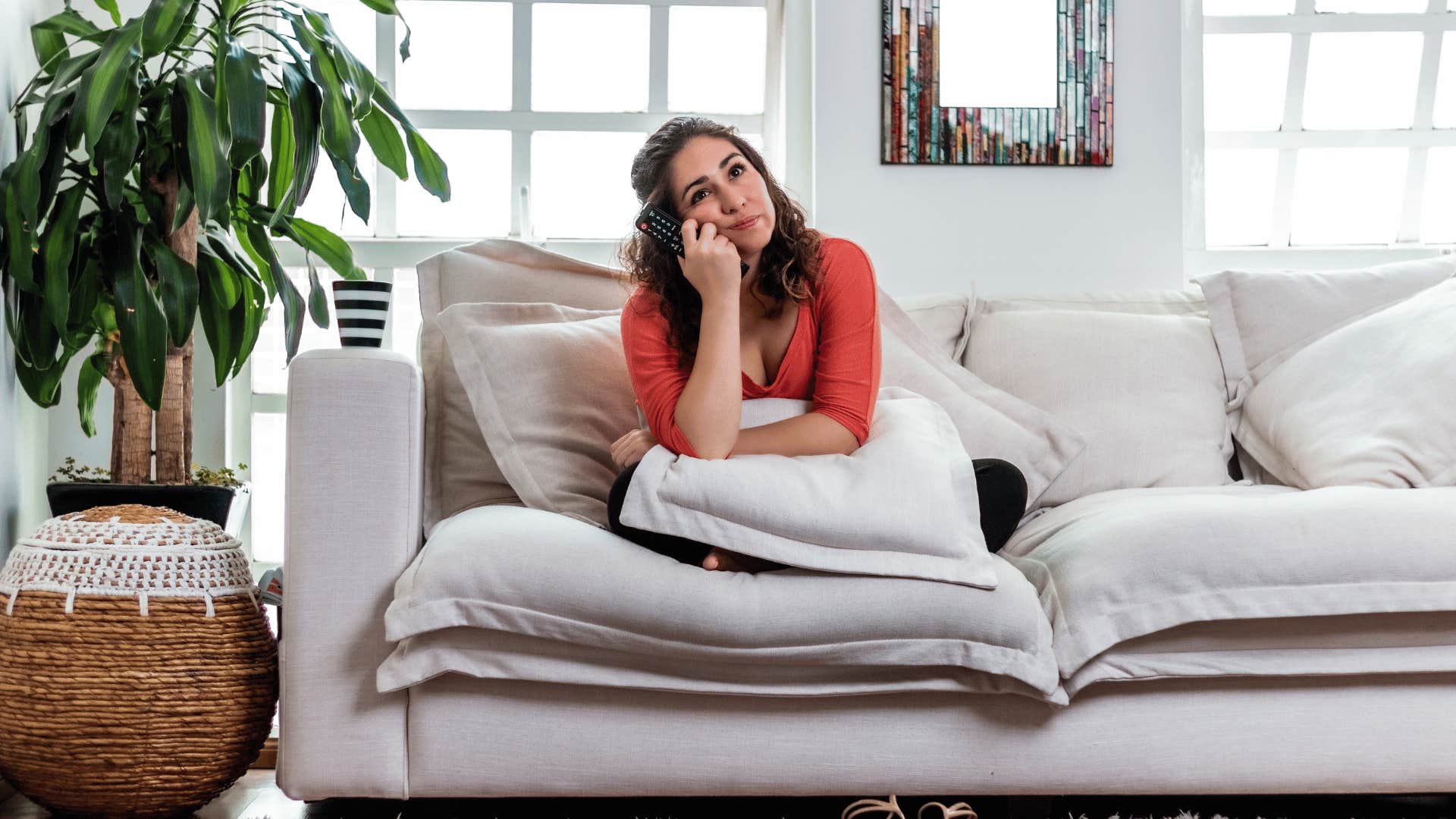 woman bored sitting on couch