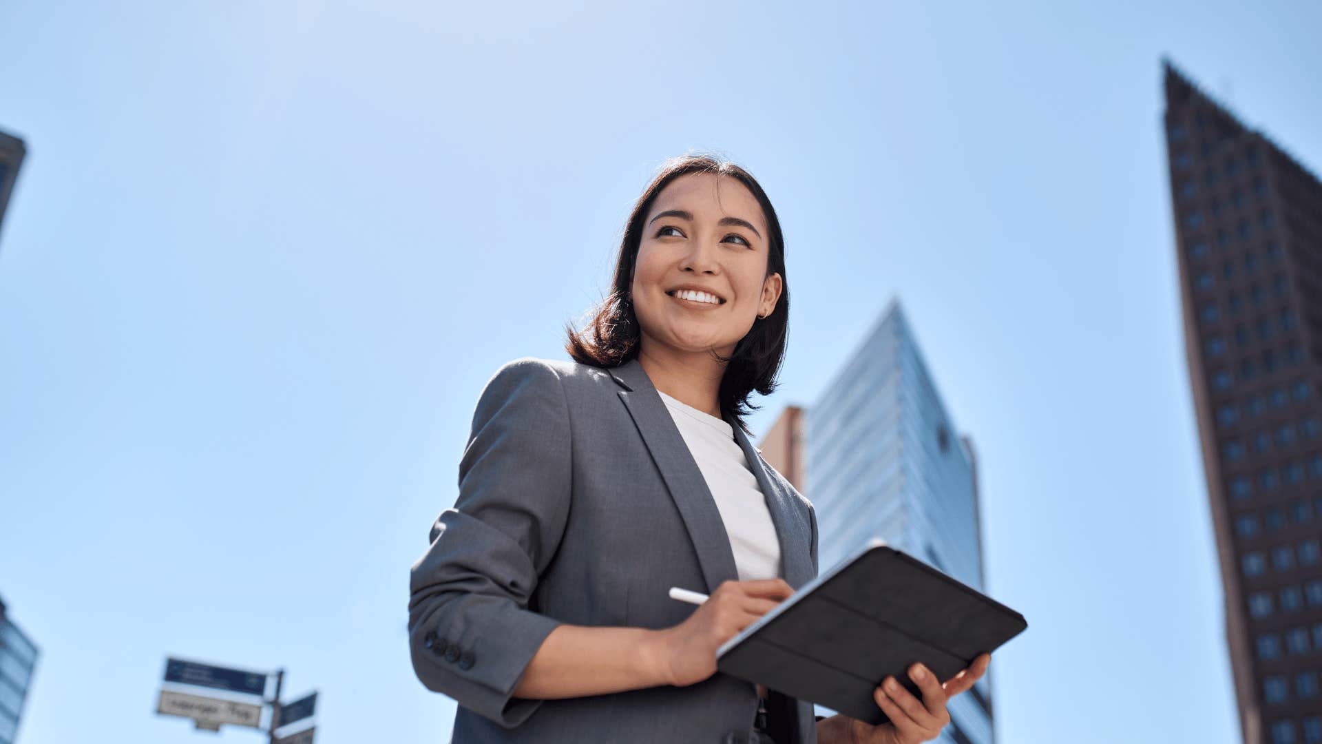 woman smiling while walking downtown