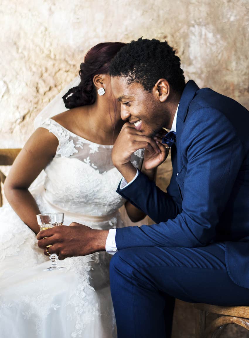 Bride whispers in groom's ear