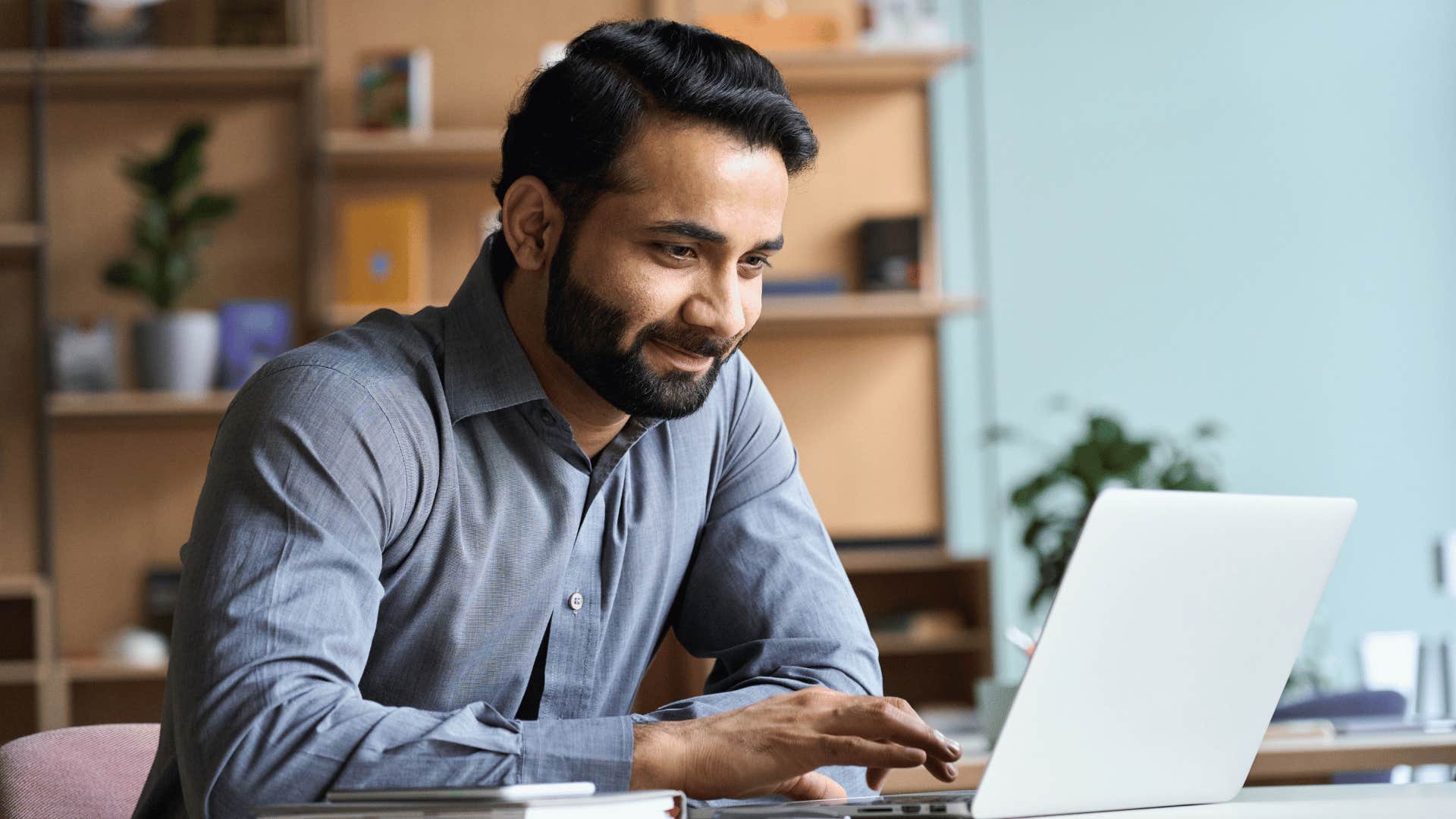 man typing on laptop