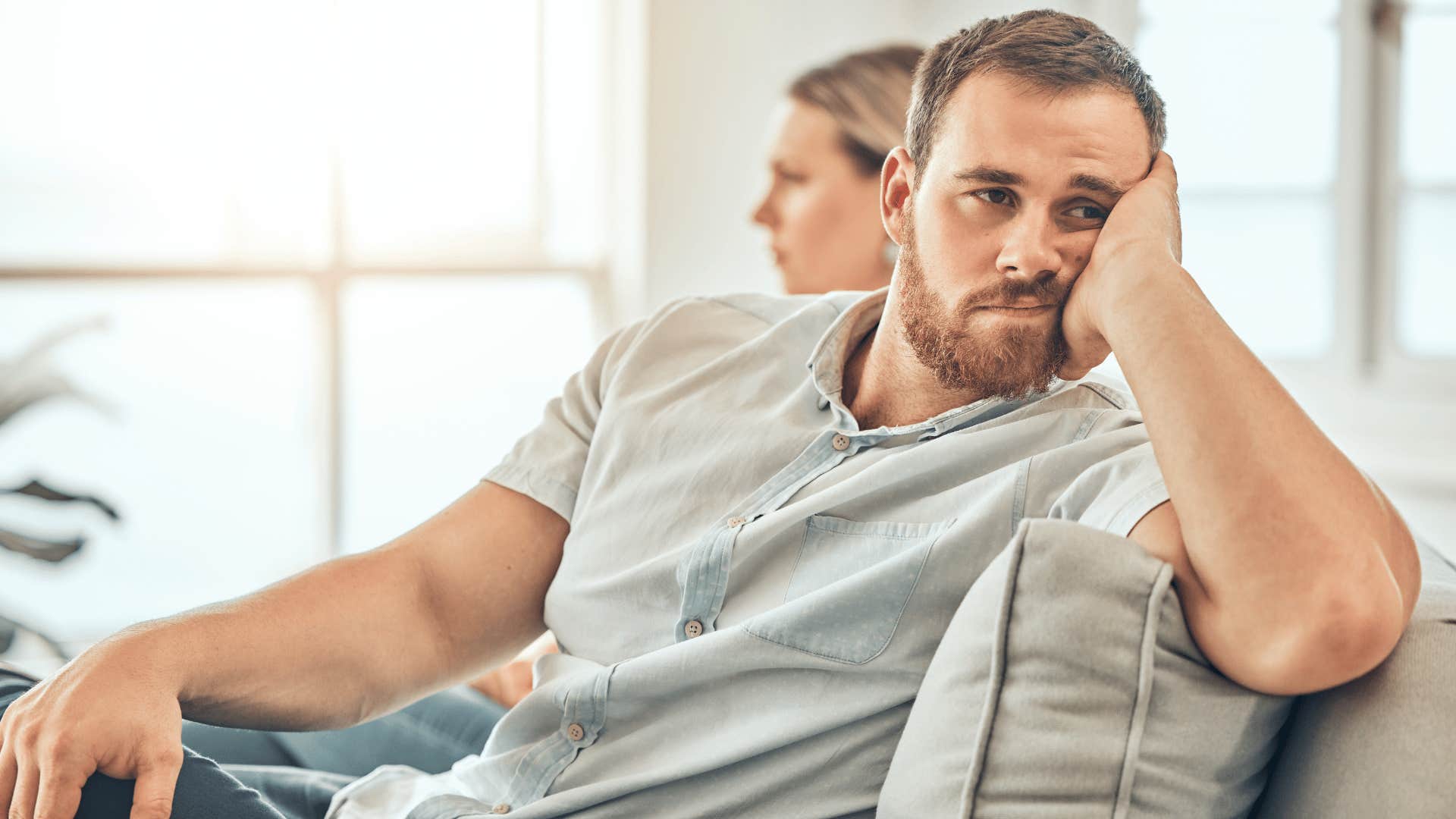 couple not talking to each other on couch