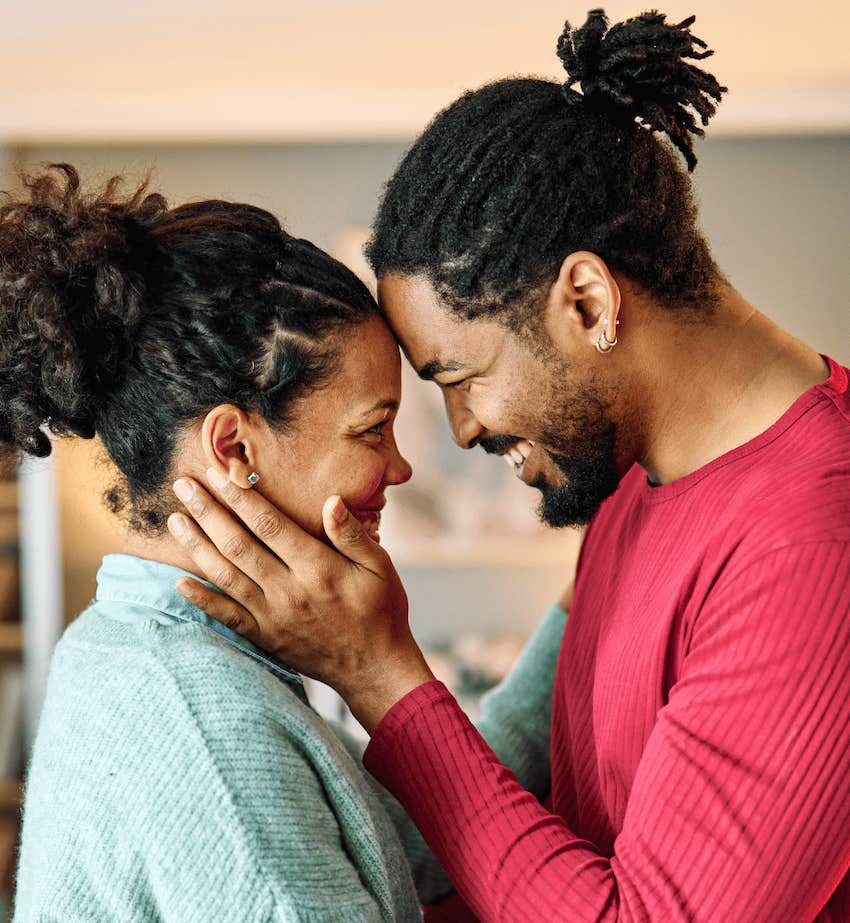 Appreciative man gently touches woman's face