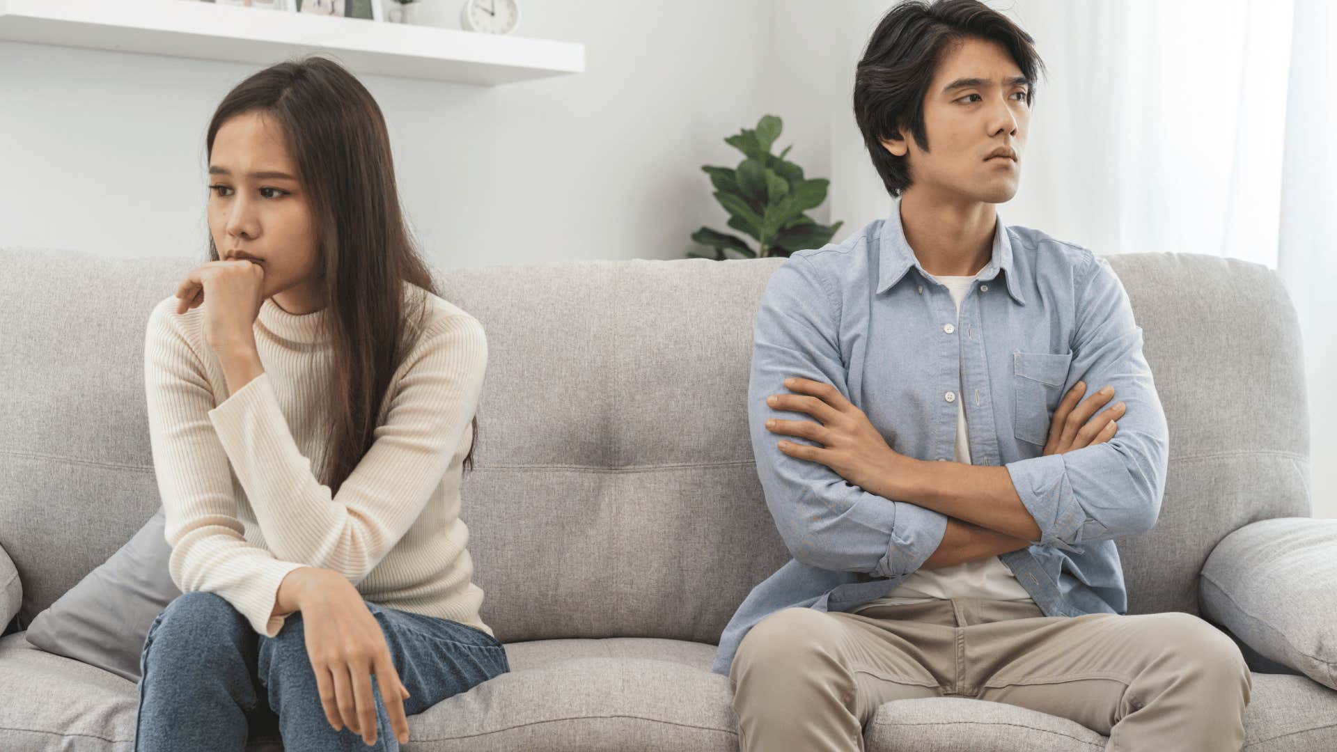 couple not talking to each other on couch