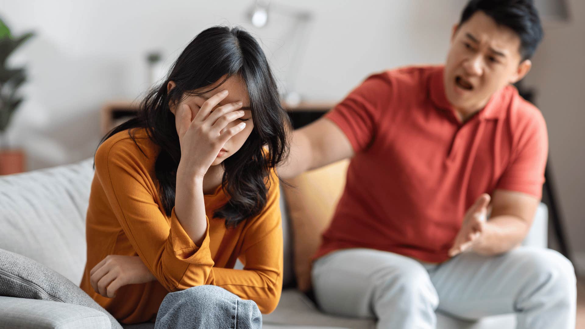 man trying to talk to upset woman