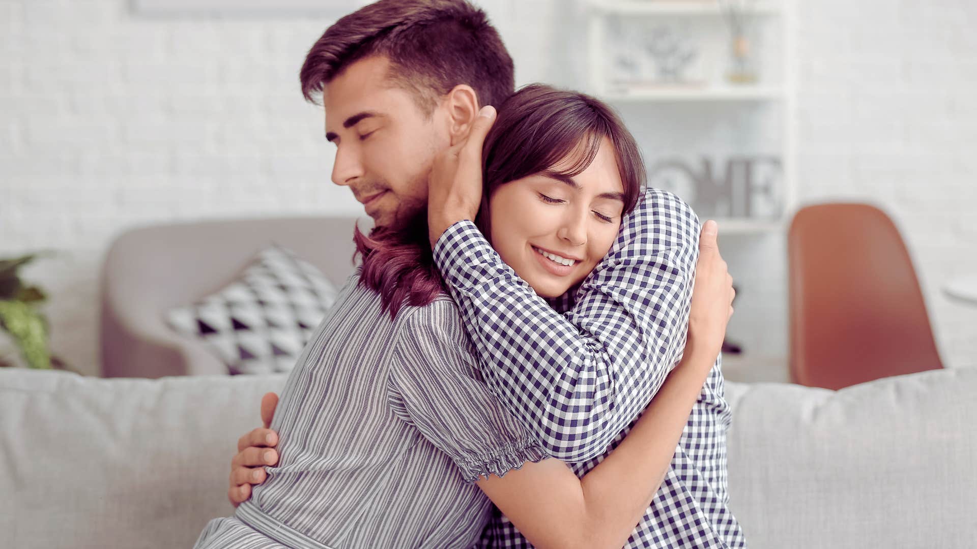 man hugging wife