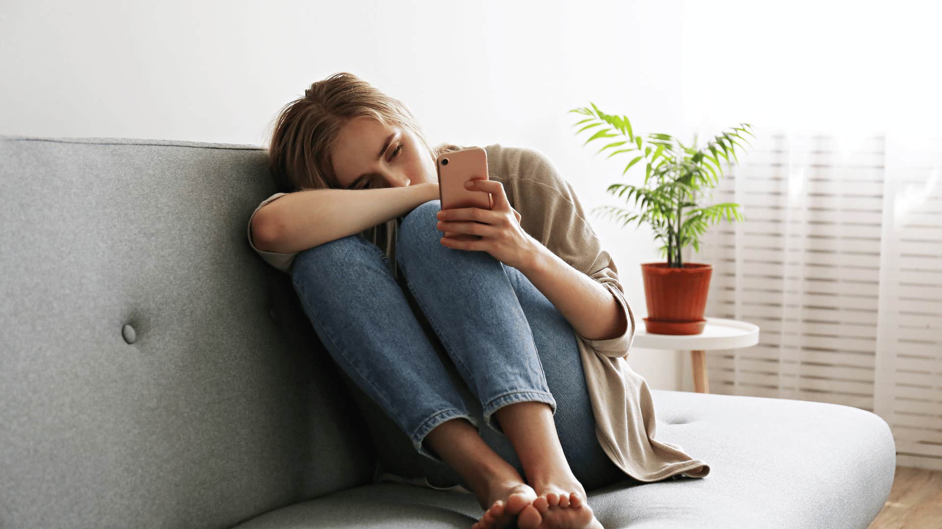 upset woman looking at phone