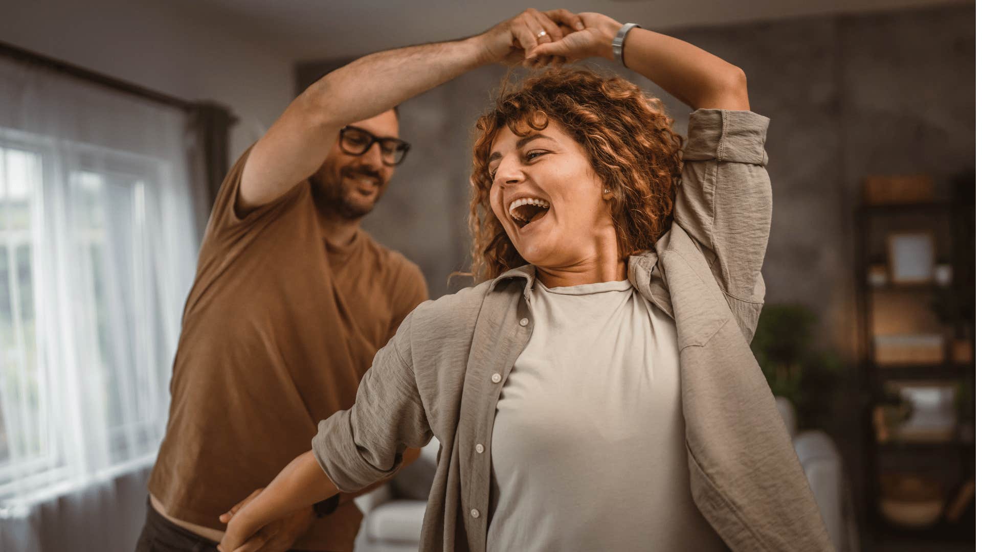 Fun couple dances like they are in a rom com