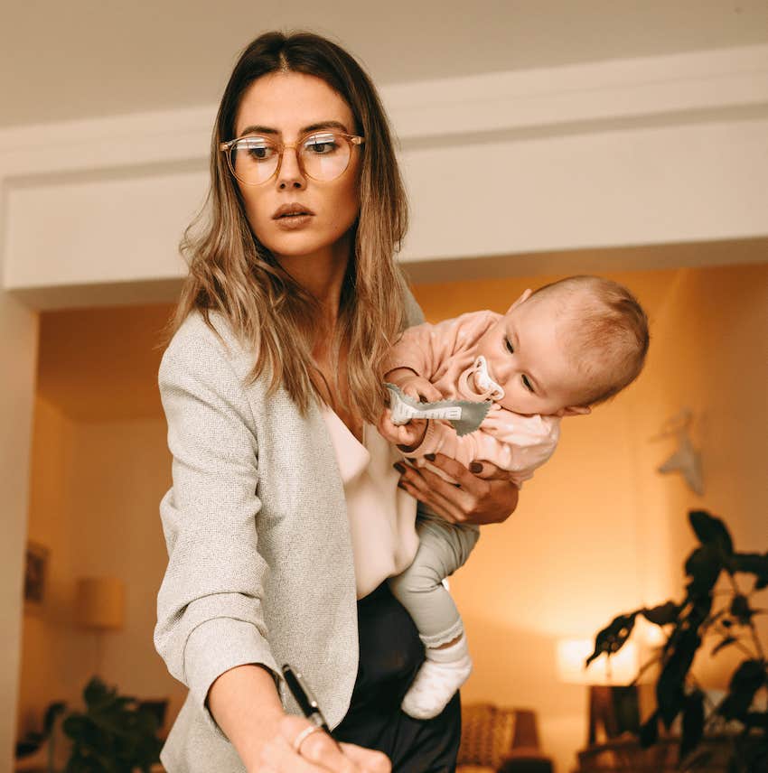 Woman tries to stay positive while working with an infant