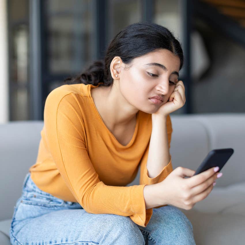 Woman bored scrolling on her phone