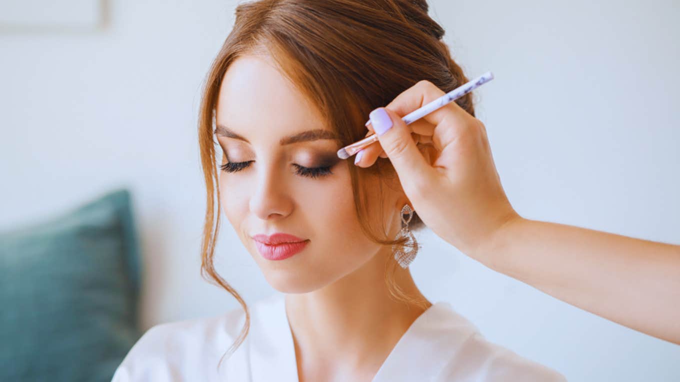 bride getting makeup done