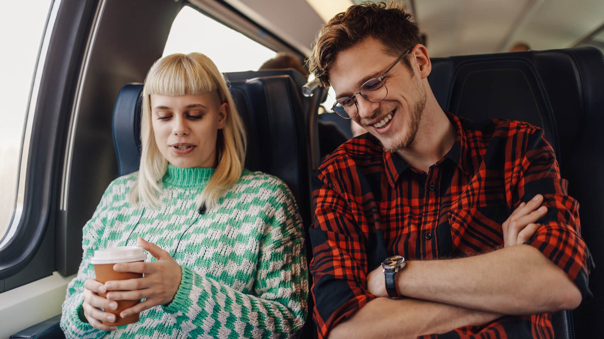 Couple smiling and sitting together on a bus