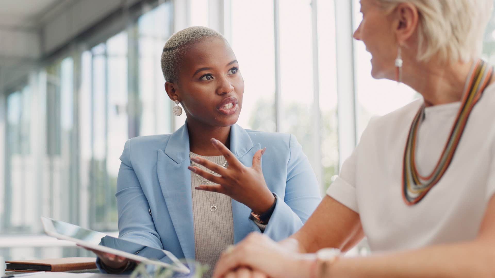 Professional woman talking to a co-worker at the office