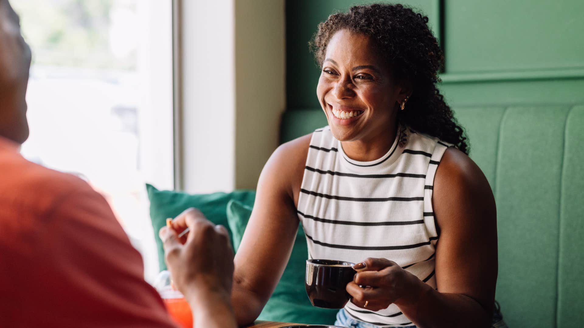 Woman smiling while talking to a man