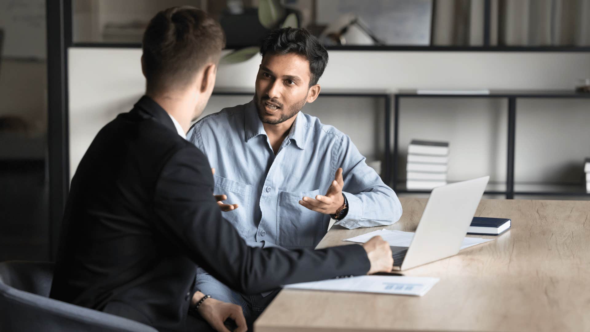 man discussing something with coworker