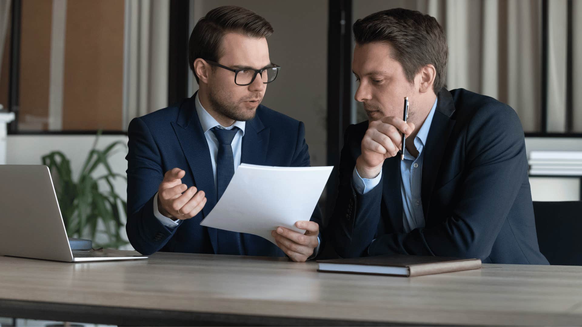 two coworkers looking at paperwork