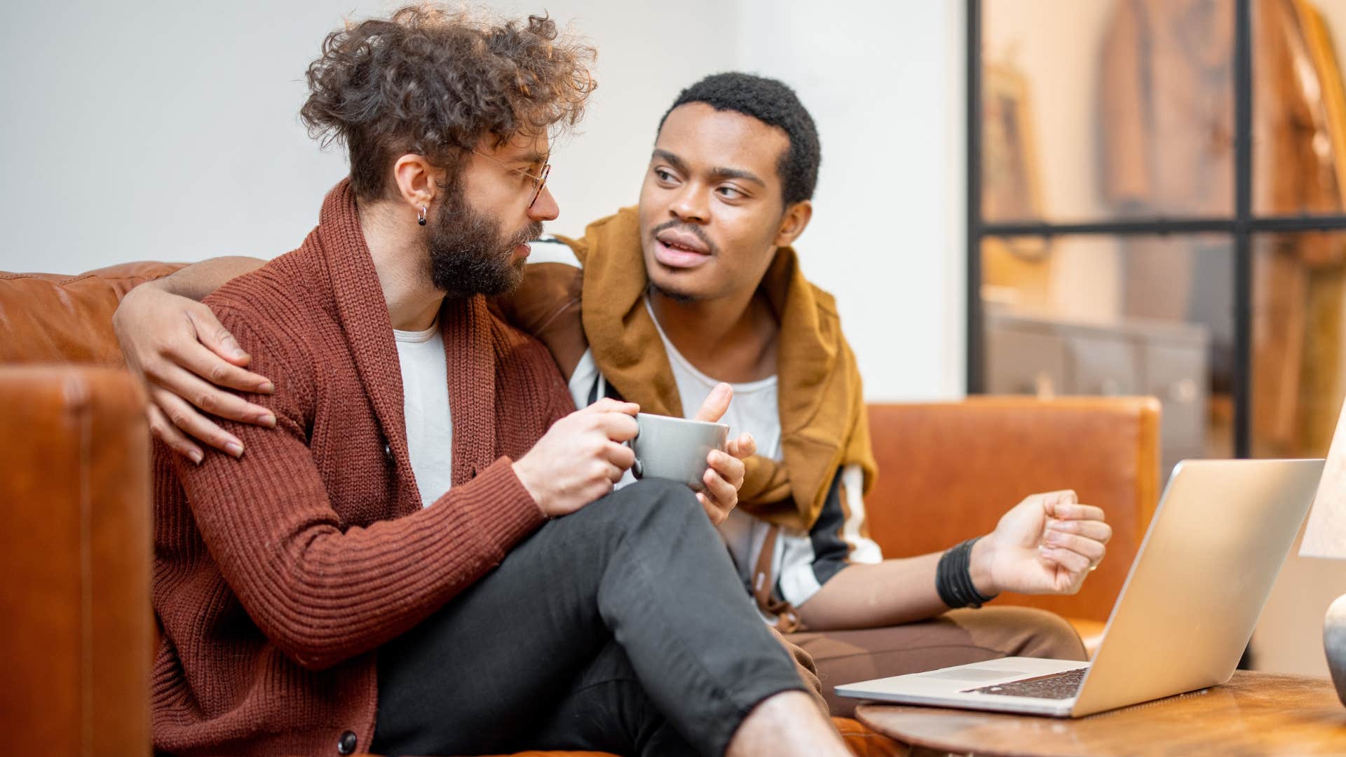 Two men smiling and talking to each other