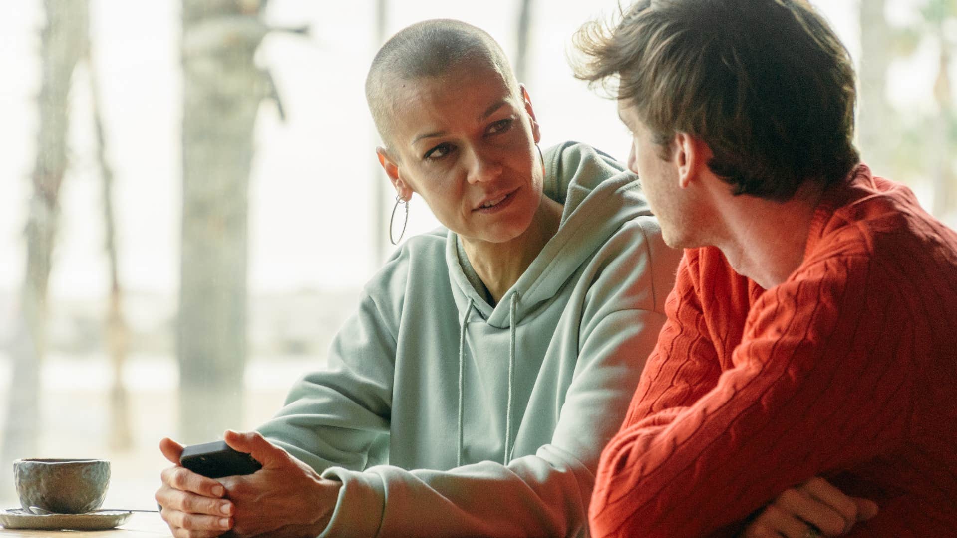 Woman having a serious conversation with a man at a table